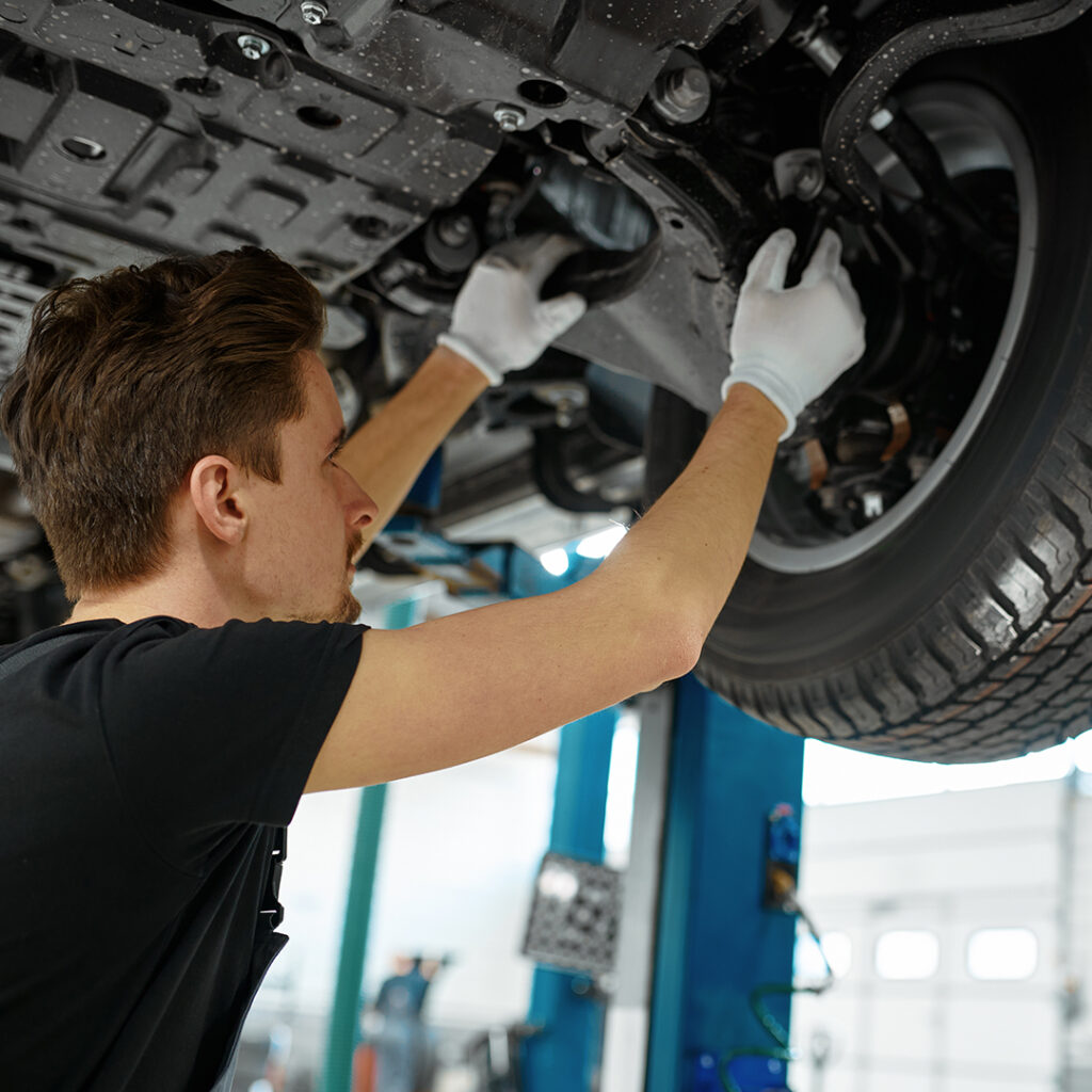 Man putting tires on car