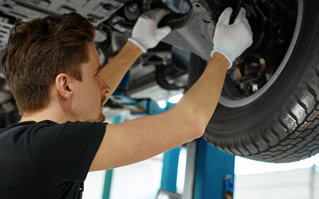 Man putting tires on car