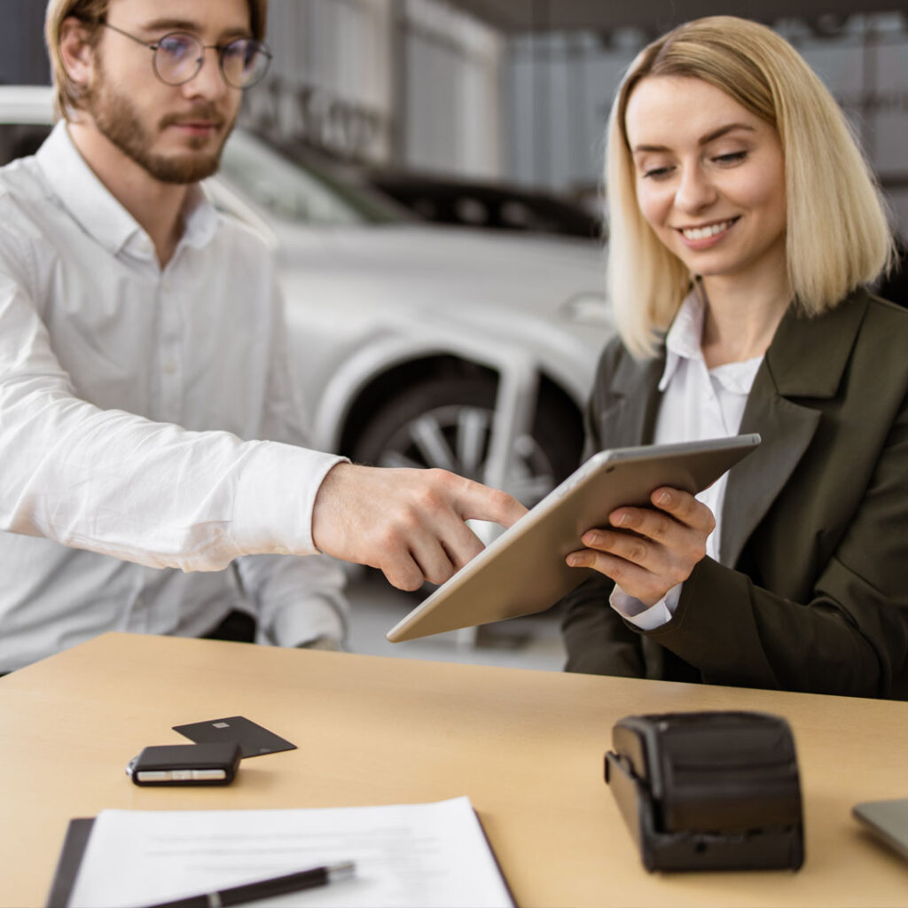 Businessman choosing auto, buying new automobile in car showroom.