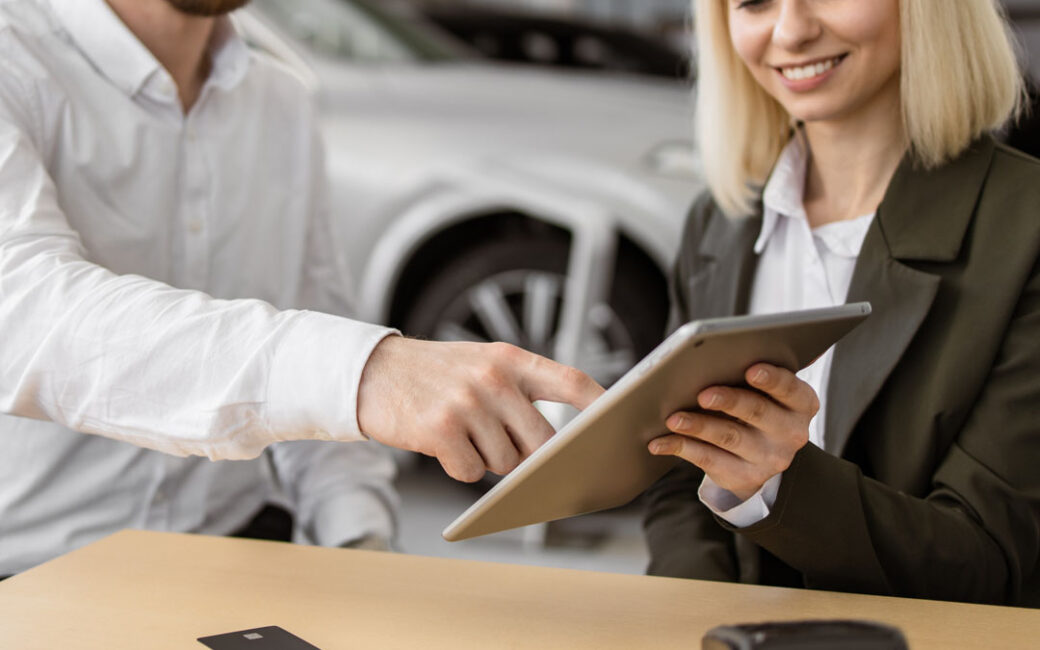 Businessman choosing auto, buying new automobile in car showroom.